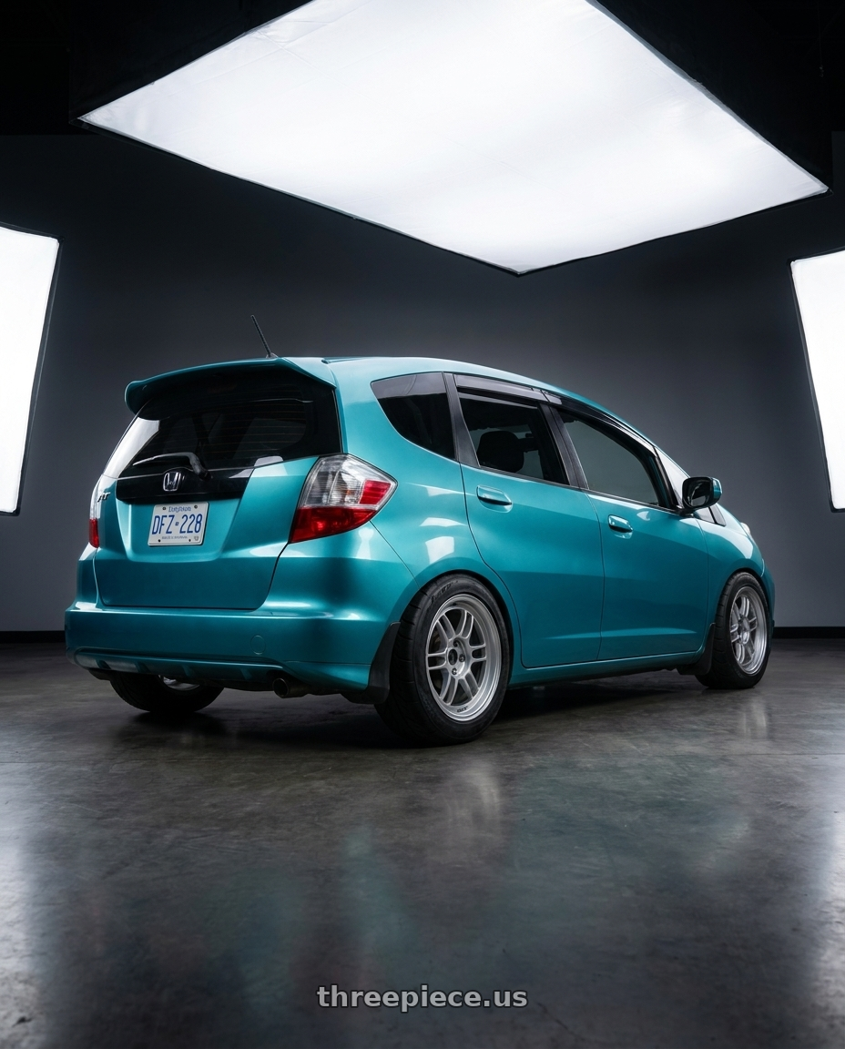 2014 Honda fit with Enkei RPF1 4x100 15x7+35 Silver wheels rear three quarter view meaty tires