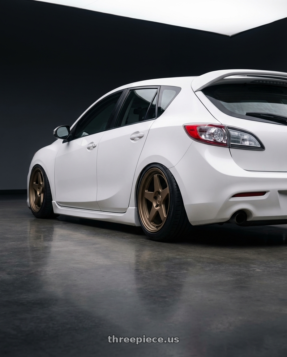 2012 Mazda Mazdaspeed3 with Kansei K12B KNP 5x114.3 18x9 12 Bronze wheels rear three quarter view slight stretch tires