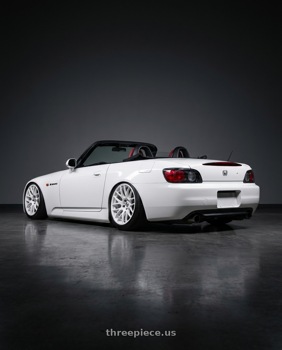 2000 Honda S2000 with Work Emotion M8R wheels rear three quarter view slight stretch tires