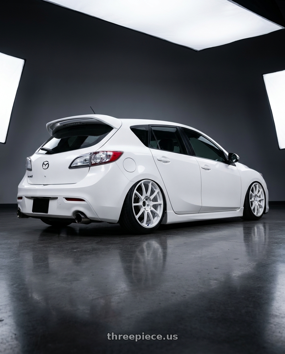 2012 Mazda Mazdaspeed3 with Advan RCIII 5x114.3 18x8.5+38 White wheels rear three quarter view slight stretch tires