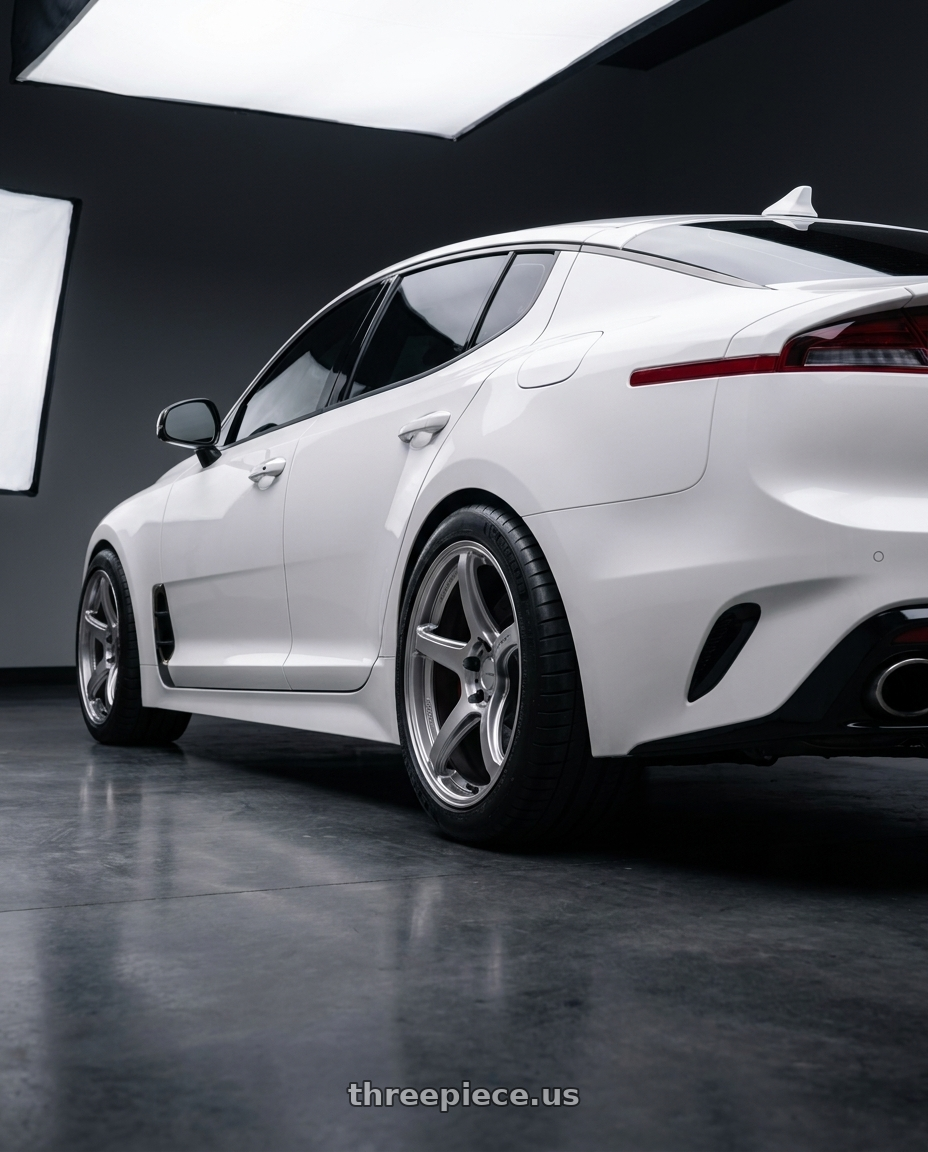 2023 Kia Stinger GT2 with Work Emotion T5r 5x114.3 19x9.5 +35 Glow Silver wheels rear three quarter view meaty tires