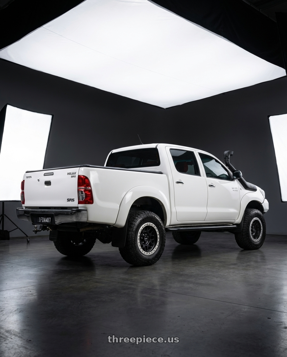2009 Toyota Hilux SR5 white with KMC KM234 GRENADE DESERT BEADLOCK 6X139.7 17X8.5 +0 SATIN BLACK wheels rear three quarter view meaty tires