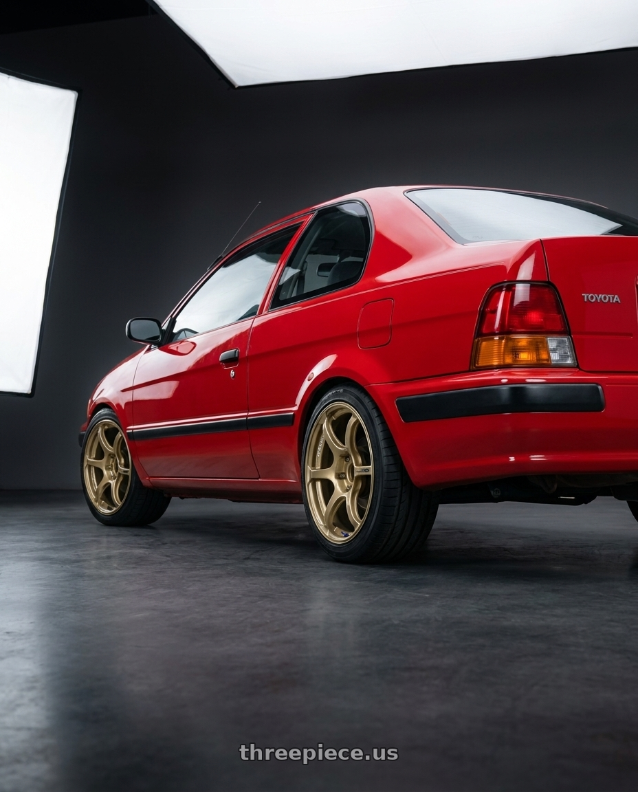 1996 Toyota Tercel El51 with Advan RGIII 4x100 18x7.0+42 Gold wheels rear three quarter view square tires