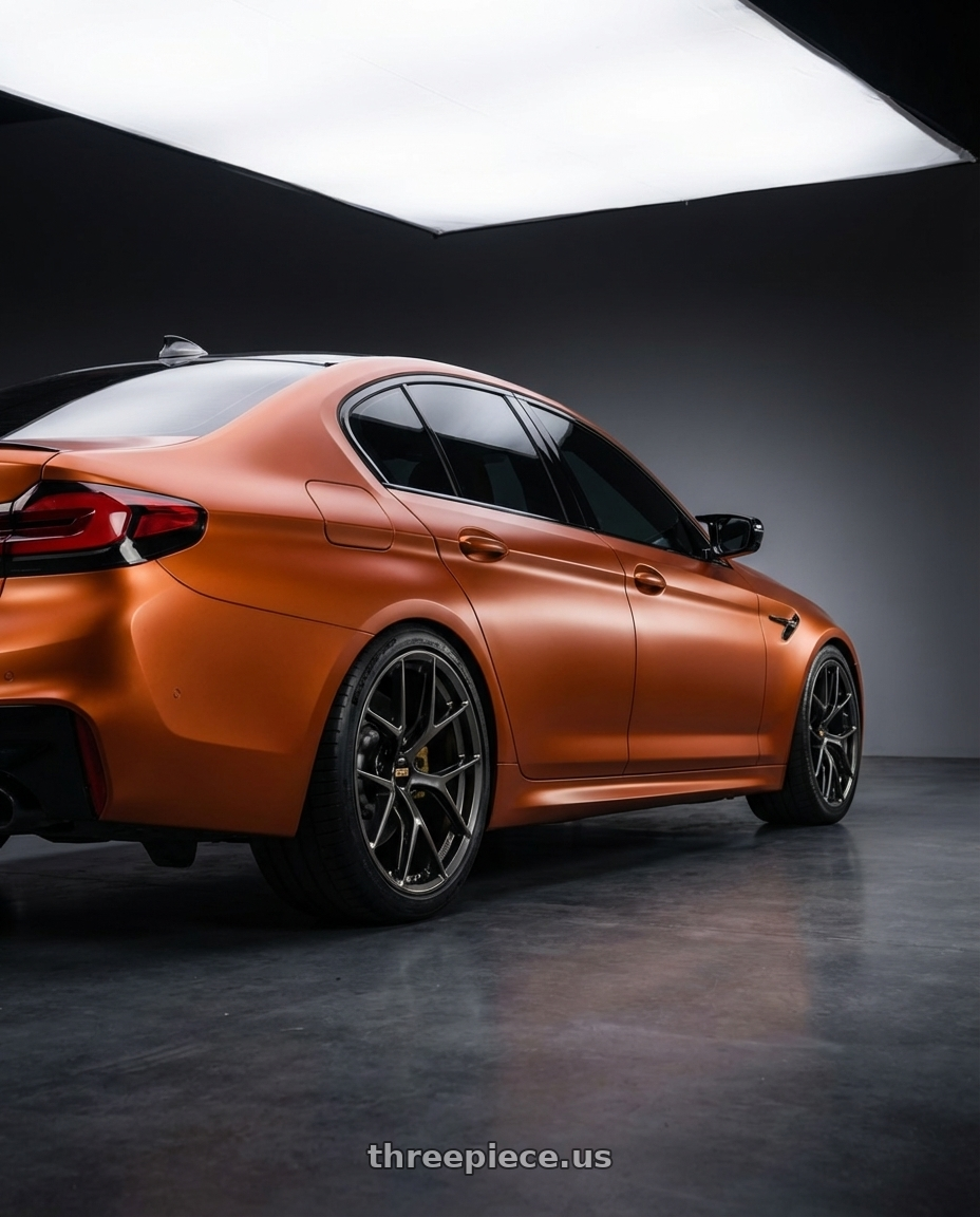 2021 bmw m5 competition orange with BBS FI-R 5x120 20x9.5+22 Diamond Black wheels rear three quarter view square tires