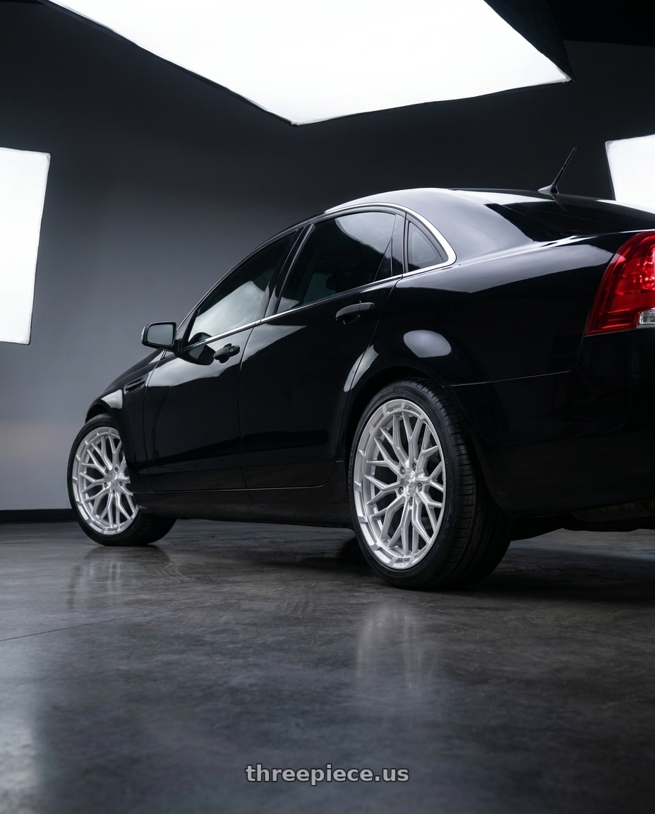 2014 Chevy caprice with DOLCE PERFORMANCE MAGARI 5x120 20x9 +35 Gloss Silver wheels rear three quarter view square tires
