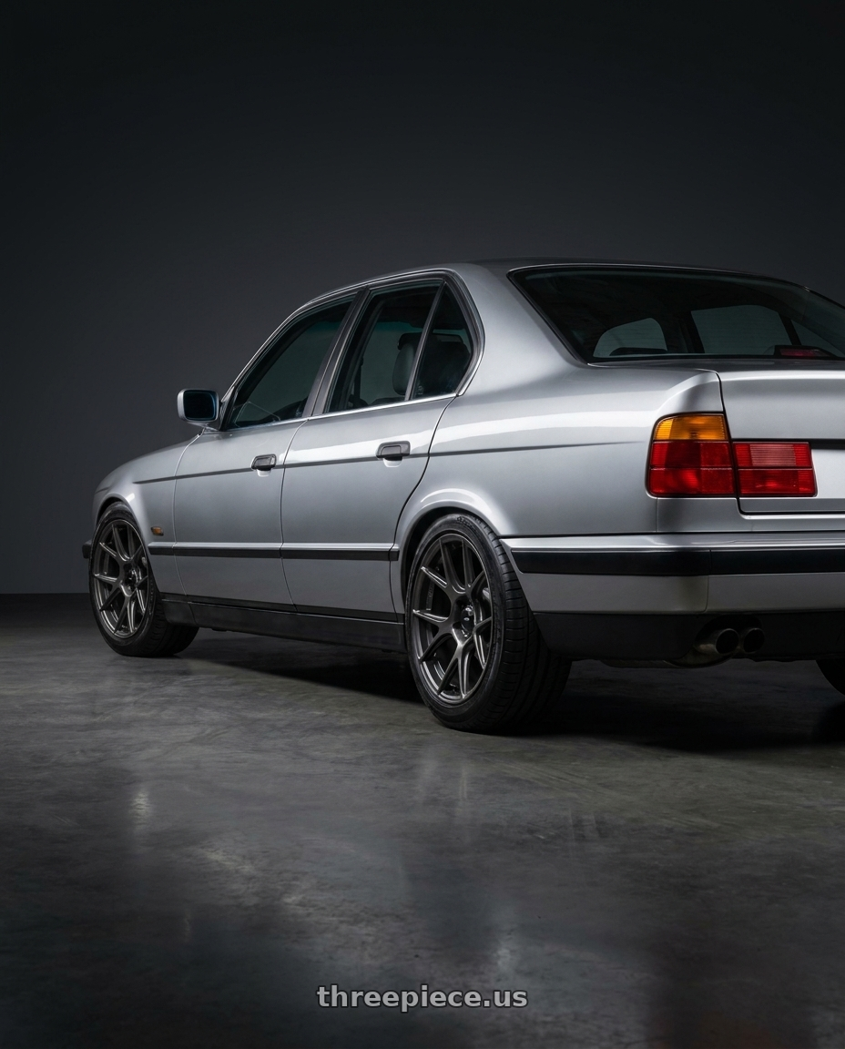 1993 Bmw E34 with Konig Ampliform 5x100 18x8.5+44 Dark Metallic Graphite wheels rear three quarter view square tires