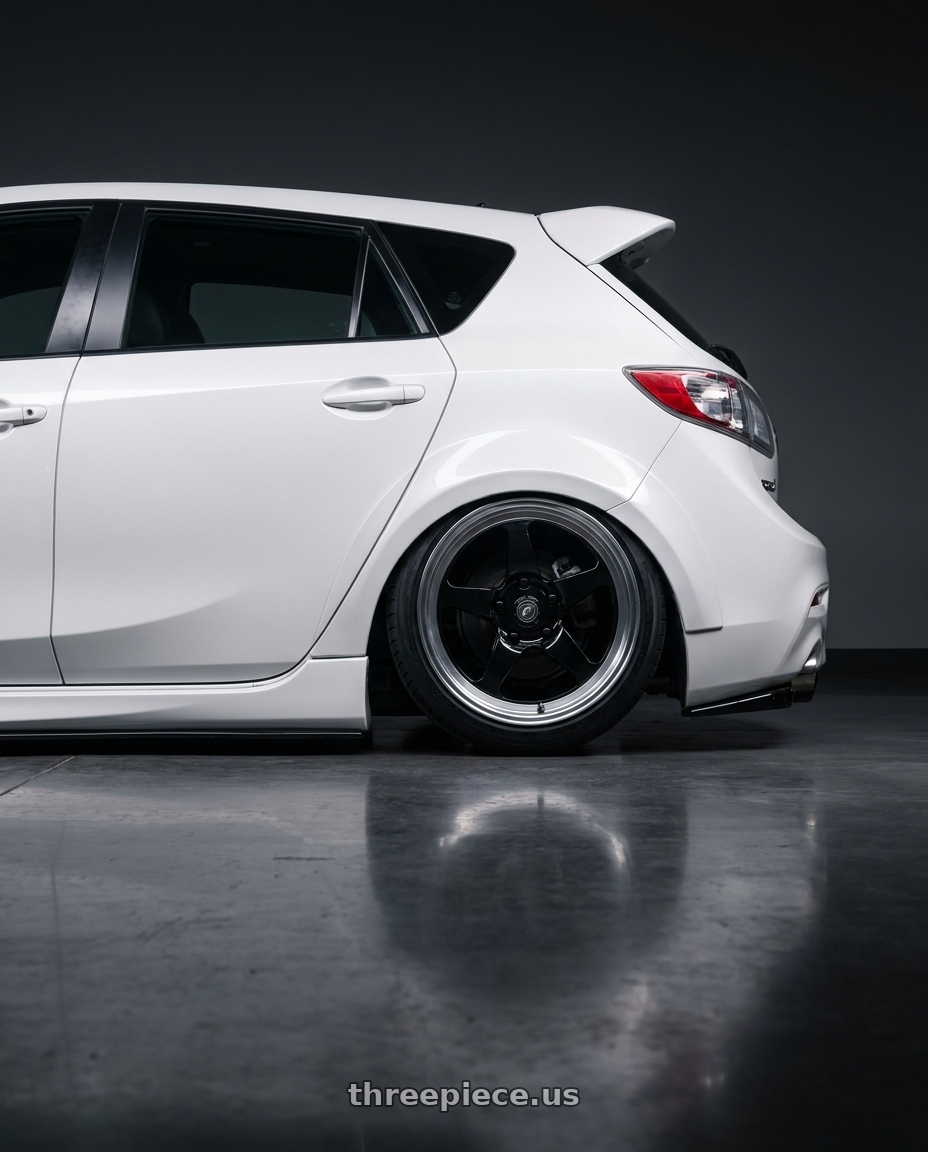 2012 Mazda Mazdaspeed3 with Forgestar D5 Drag 5x114.3 18x10 +42 Gloss Black Machined wheels rear three quarter view slight stretch tires