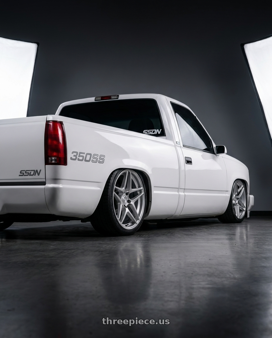 1989 chevy c1500 with Kansei K15H Astro 5X112 19x8.5 35 Hyper Silver wheels rear three quarter view square tires