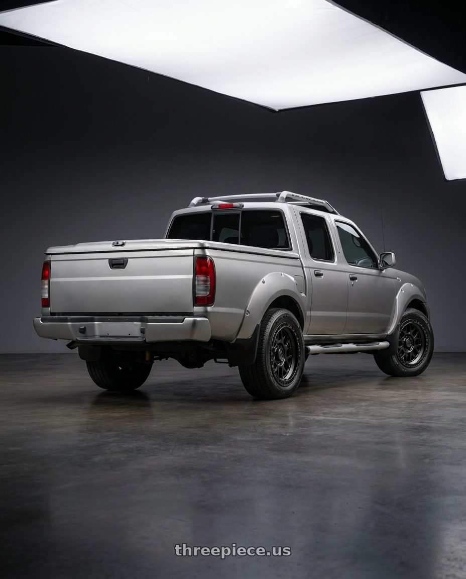 2001 Nissan Frontier with KMC KM549 GRS 6X139.7 17X8.5 +0 SATIN BLACK wheels rear three quarter view square tires