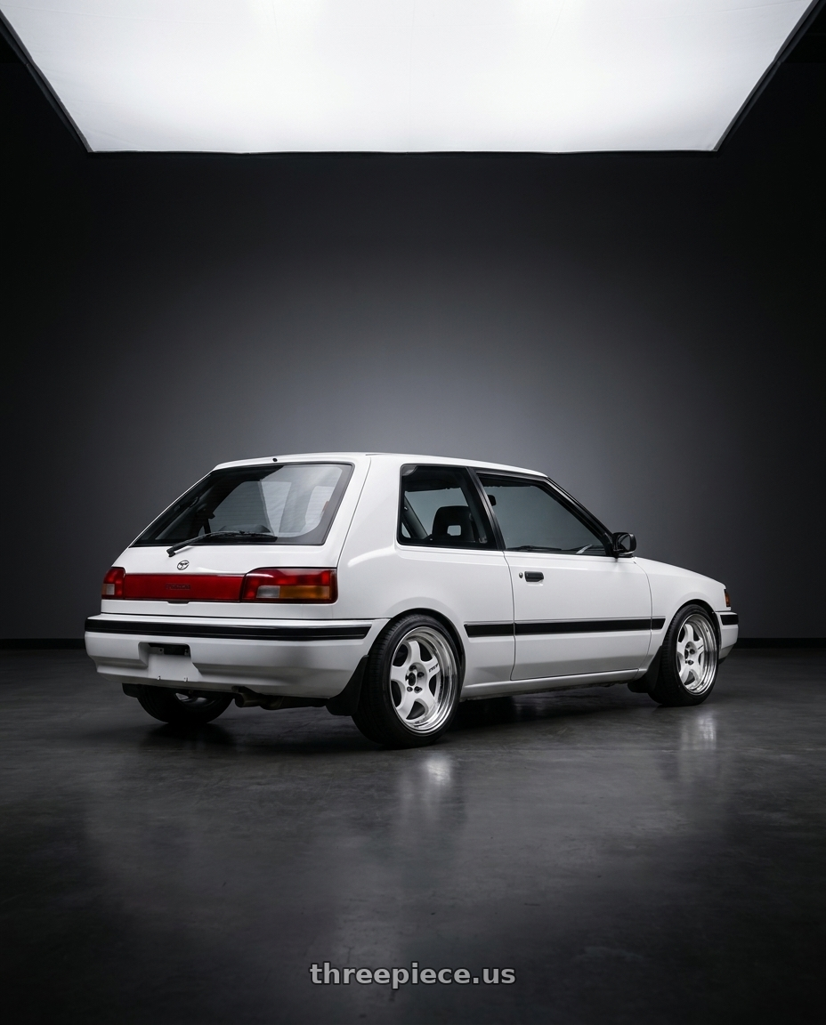 1992 mazda 323 hatchback white with Work Meister S1 2P 4x100 15x7+38 R Disk White wheels rear three quarter view square tires