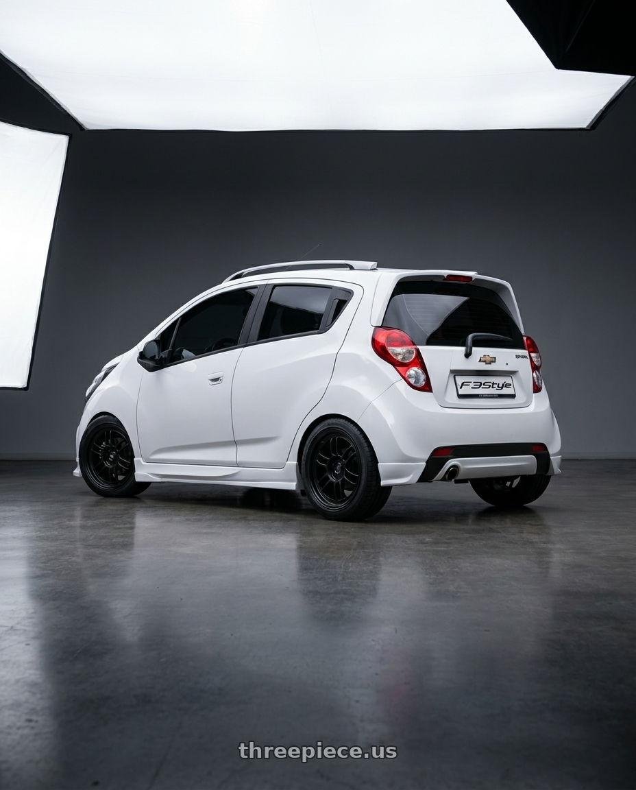 2015 Chevy Spark LS with Enkei RPF1 4x100 17x7+43 Matte Black wheels rear three quarter view square tires