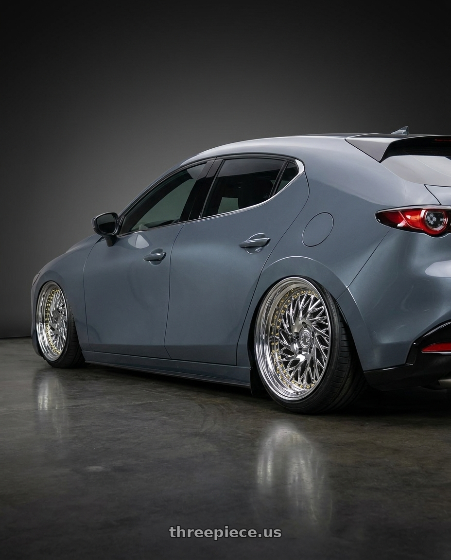 2023 Mazda Mazda3 Turbo with Aodhan DS03 5x114.3 18x9.5 +30 Vacuum Chrome w/Gold Rivets wheels rear three quarter view slight stretch tires