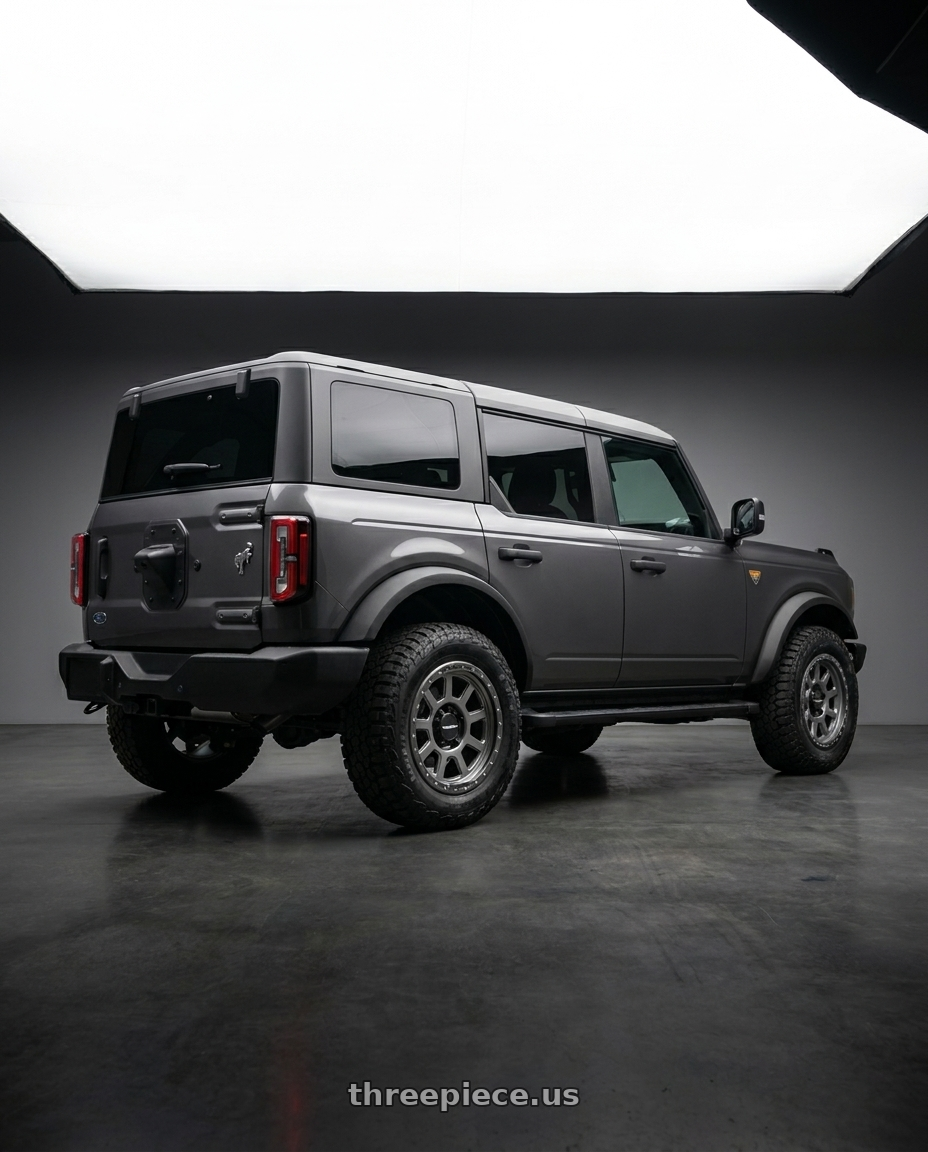 2023 Ford Bronco Badlands with Vision Off-Road 350 Ojos 6x139.7 17x9+12 Satin Grey wheels rear three quarter view square tires