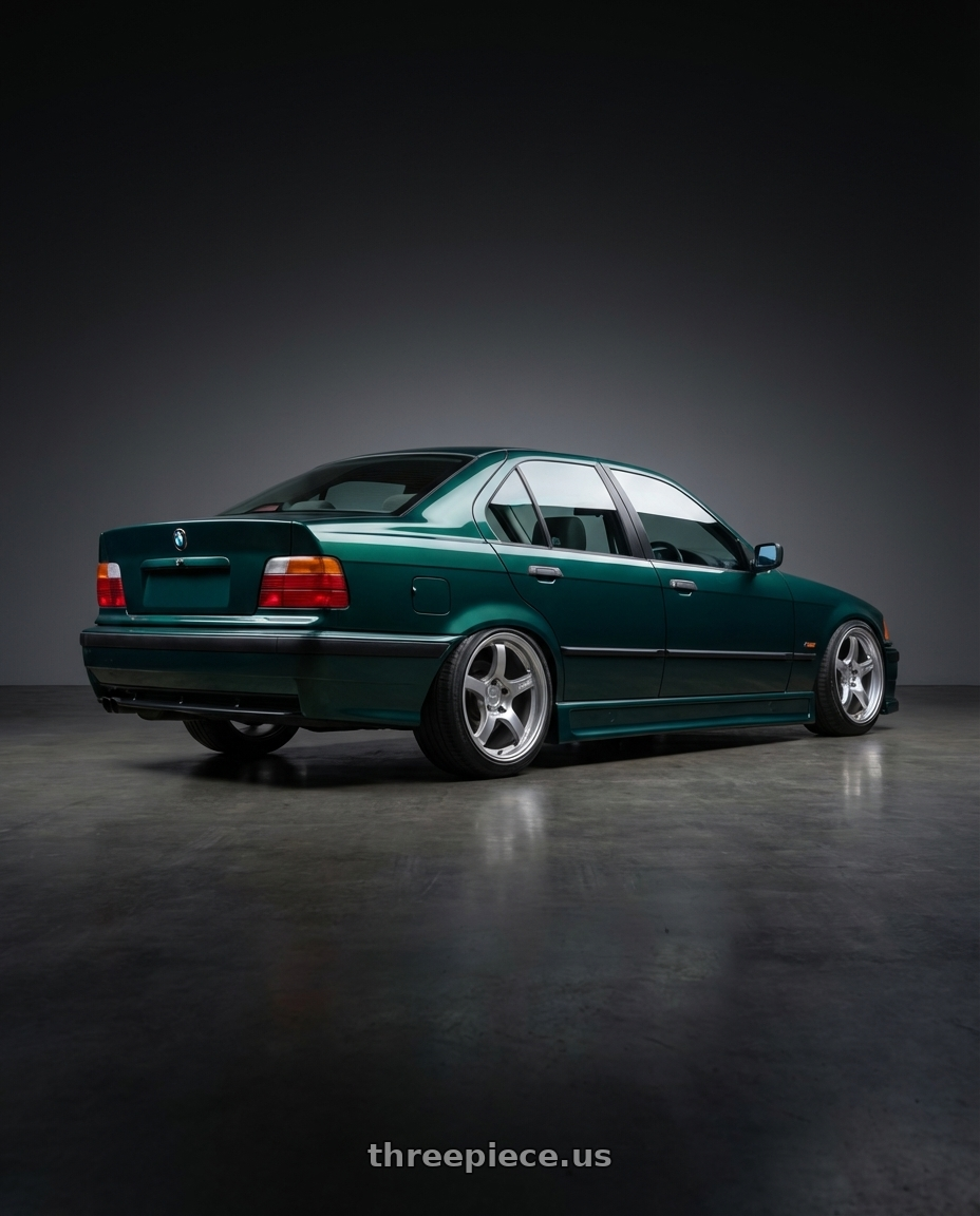 1997 e36 sedan boston green bomex with Gram Lights 57CR 5x114.3 18x9.5+38 Grace Silver wheels rear three quarter view slight stretch tires