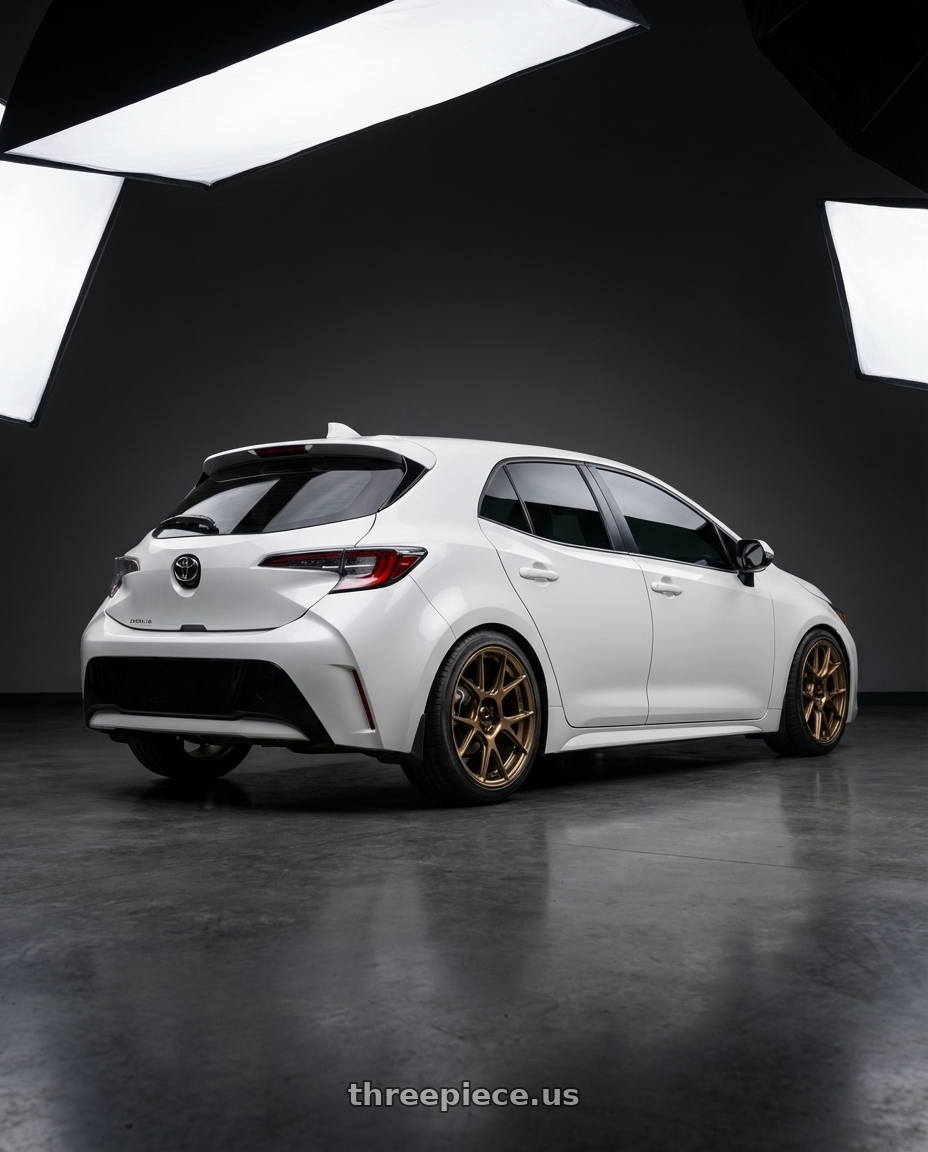 2023 Toyota Corolla Hatchback with Konig Ampliform 5x114.3 18x9.5+35 Gloss Bronze wheels rear three quarter view square tires