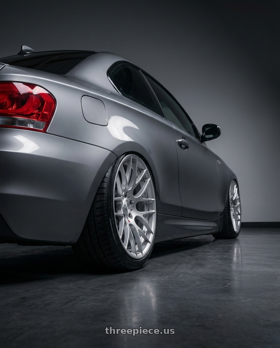 2012 BMW 1 Series E82 with Avant Garde Wheels M359 5X120 18x9.5 +22 Hyper Silver wheels rear three quarter view slight stretch tires