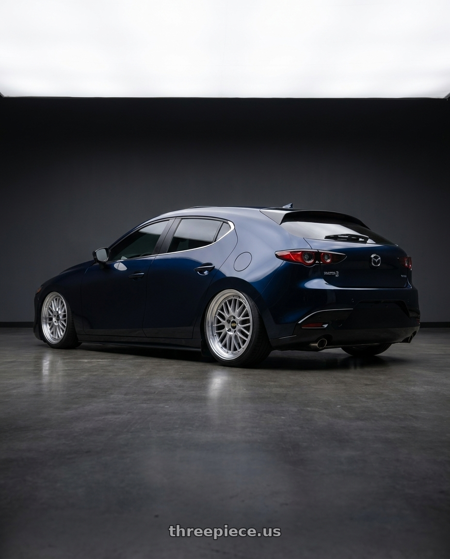2025 Mazda 3 Deep Mica blue with AeroKit with BBS LM 5x114.3 19x9.0+38 Diamond Silver wheels rear three quarter view slight stretch tires