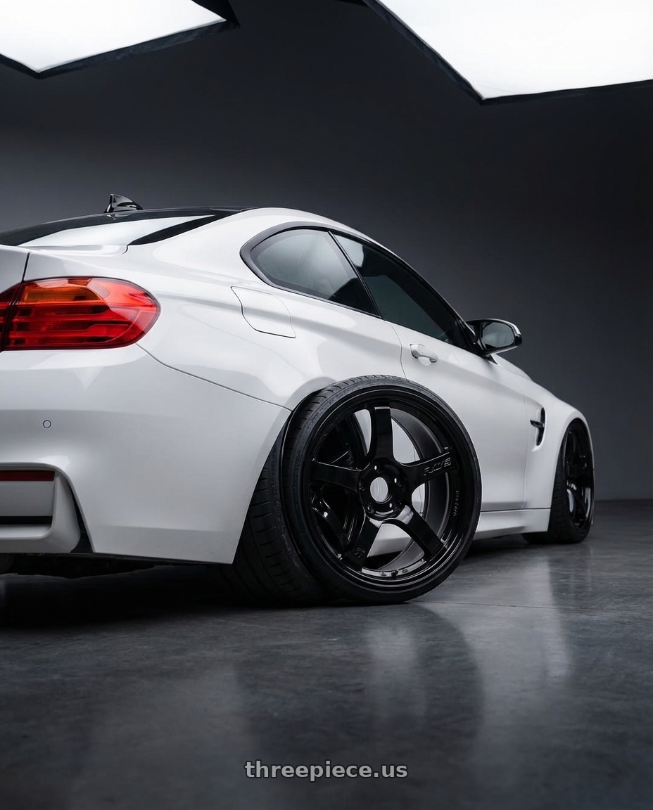 2018 BMW M4 F82 with Gram Lights 57CR 5x120 19x10.5+22 Glossy Black wheels rear three quarter view slight stretch tires