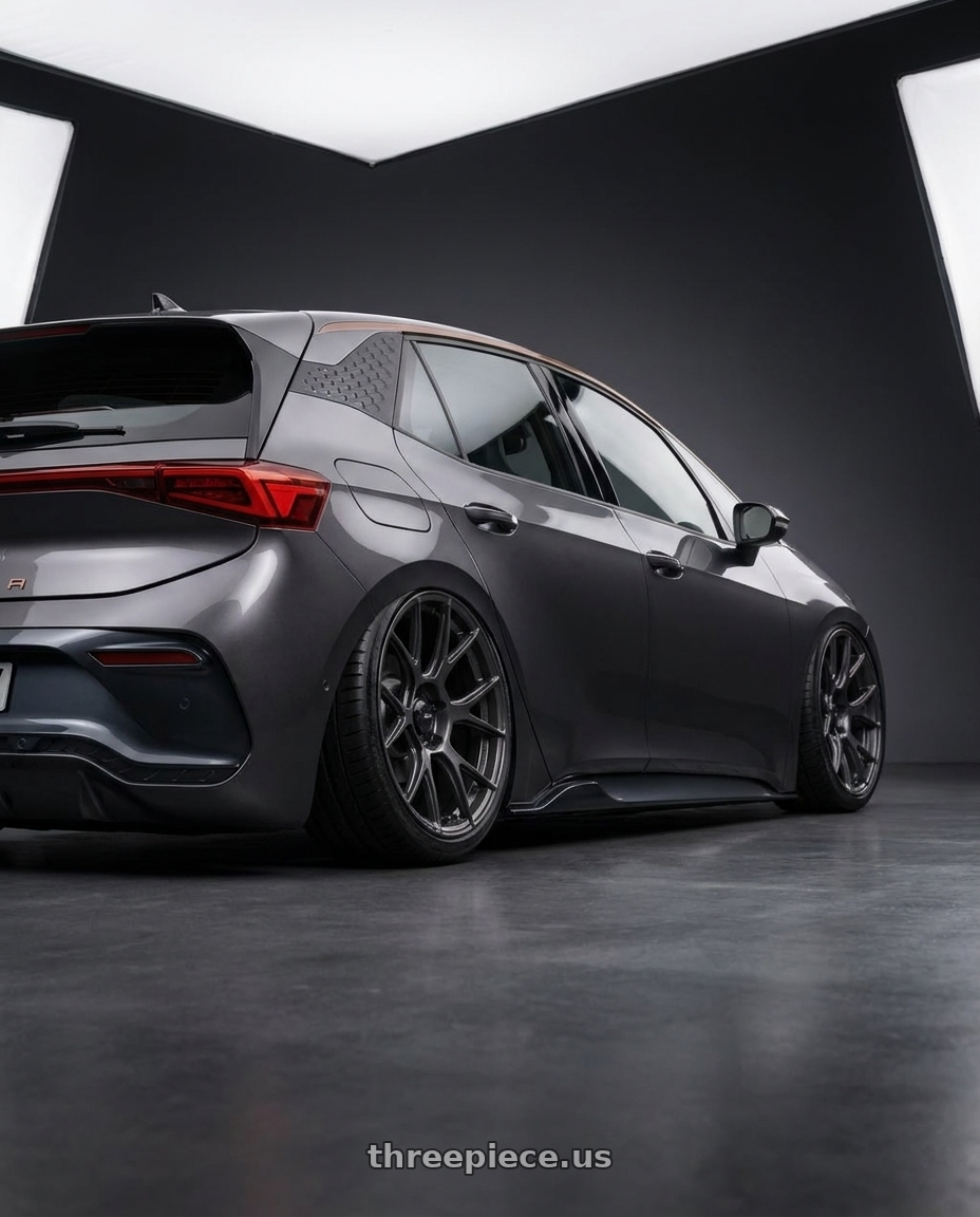 2026 Cupra Raval with Konig Ampliform 5x114.3 19x9.5+25 Dark Metallic Graphite wheels rear three quarter view extreme stretch tires