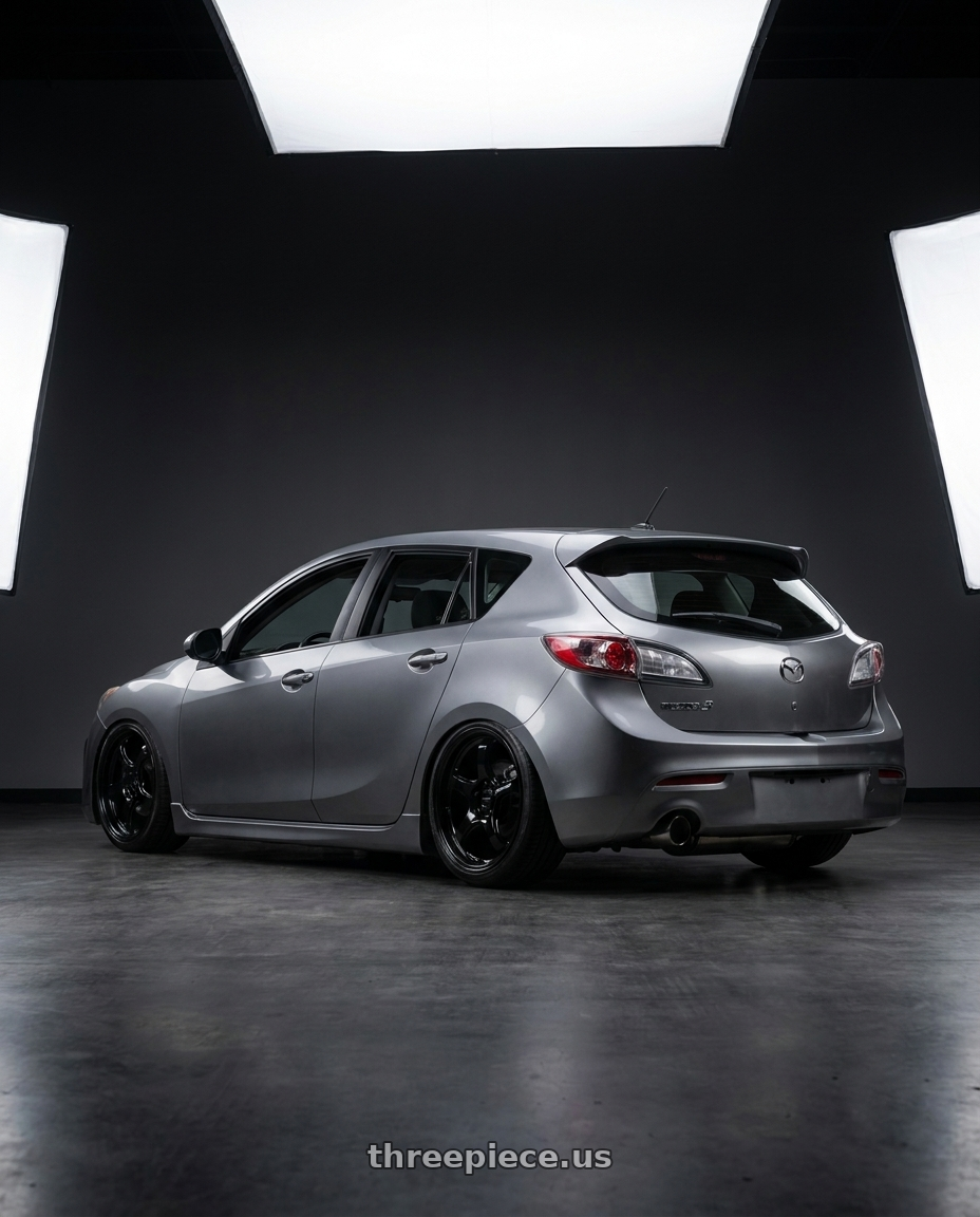 2011 Mazda 3 Hatch with WedsSport RN-05M 5x114.3 19x9.5+48 Gloss Black wheels rear three quarter view slight stretch tires
