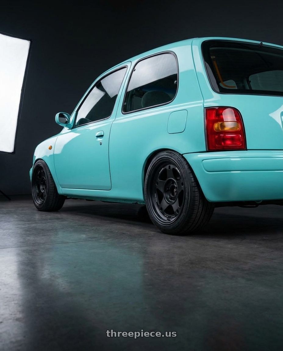 1996 NISSAN MARCH Tiffany Blue with Volk Racing RAYS 05X 6x135 17x8.5 -10 BLAST BLACK 2 wheels rear three quarter view square tires