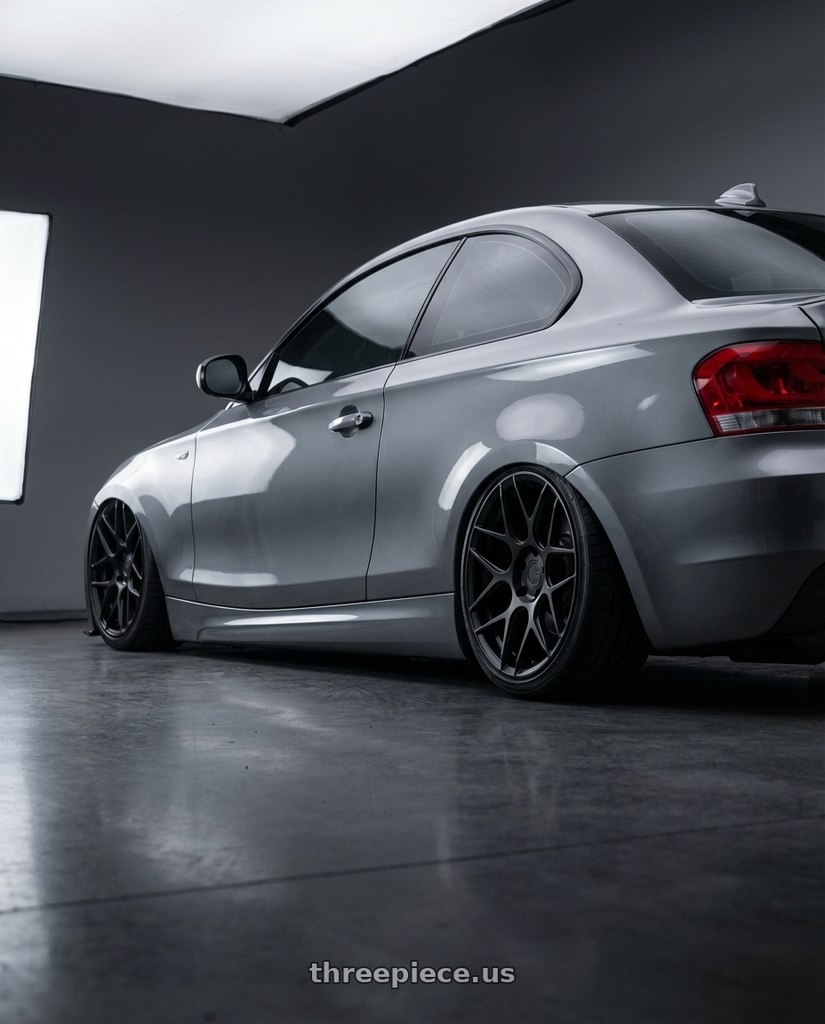 2012 BMW 1 Series E82 with Aodhan AFF2 5x120 19x9.5+35 Matte Black wheels rear three quarter view slight stretch tires