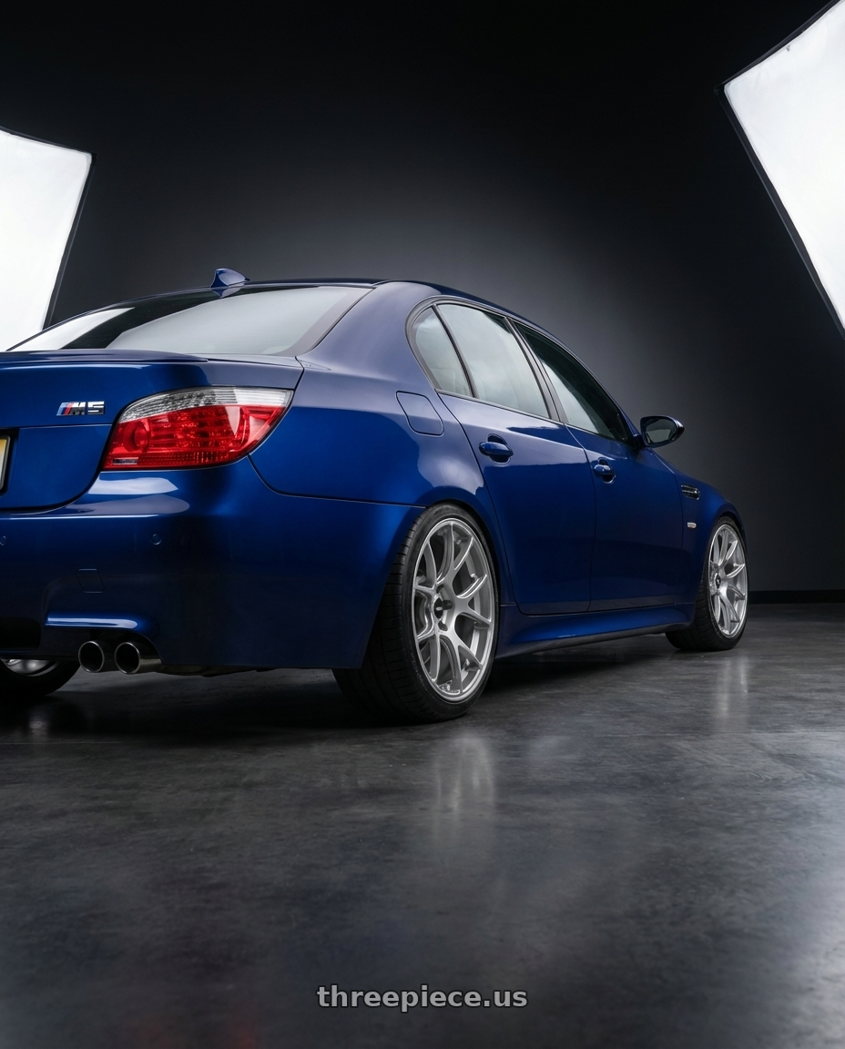 2010 BMW M5 E60 with Konig Forged F1M 5X120 19x11+44 Ash Silver Knurled Bead wheels rear three quarter view square tires