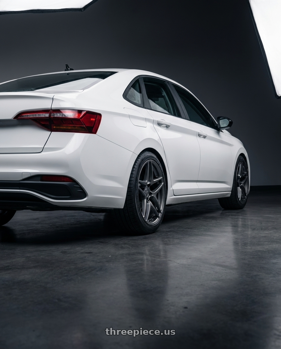 2026 vw jetta with Kansei K15G Astro 5x114.3 18x9 22 Gunmetal wheels rear three quarter view square tires