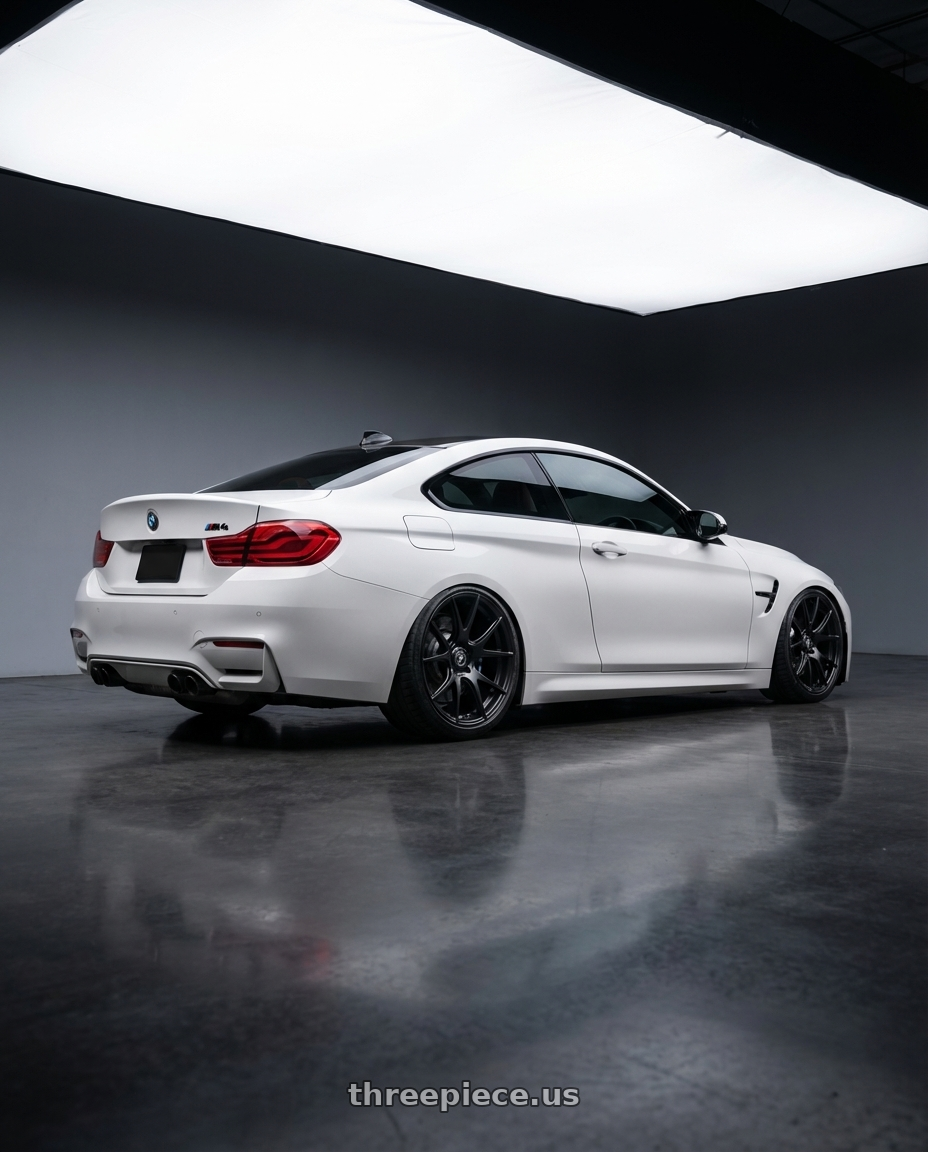 2018 BMW M4 F82 with Forgestar CF5V 5x120 19x9 +38 Satin Black wheels rear three quarter view slight stretch tires