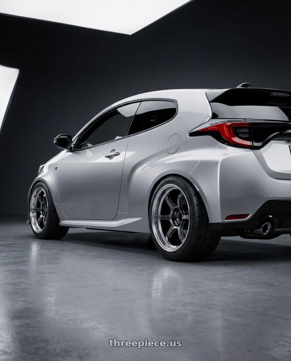 2026 GR Yaris RZ Silver with Advan Racing R6 5x114.3 18x9.5 +29 MACHINING & HYPER PLATINUM BLACK wheels rear three quarter view meaty tires