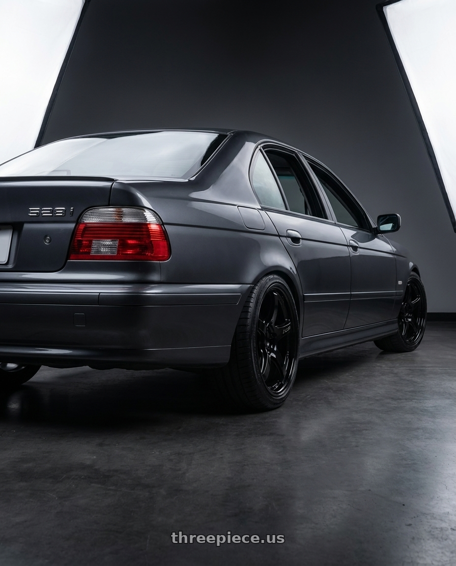 2000 BMW 528i Grey with Gram Lights 57CR 5x100 18x9.5+38 Glossy Black wheels rear three quarter view slight stretch tires