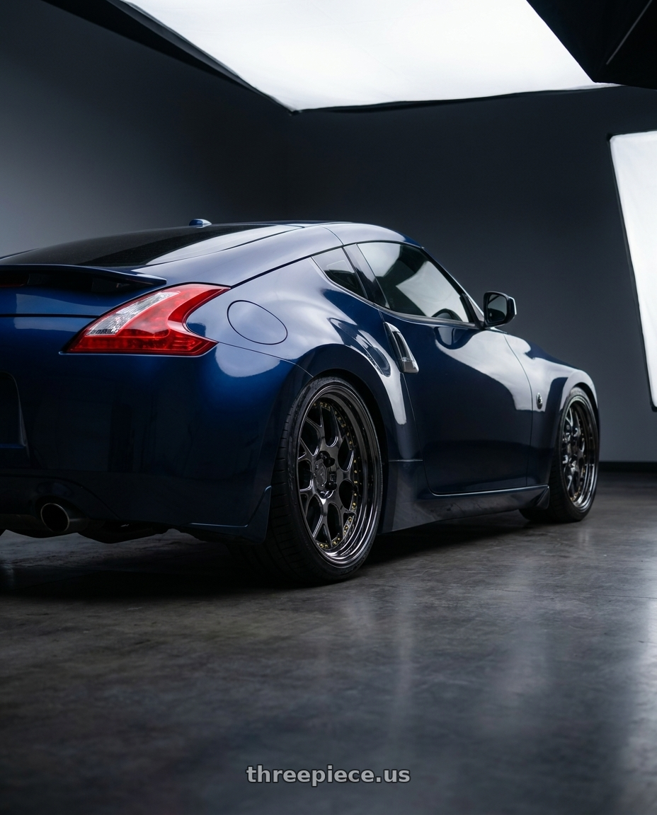 2016 Nissan 370z with Aodhan DS01 5x114.3 19x10.5+22 Black Vacuum W/ Gold Rivets wheels rear three quarter view square tires