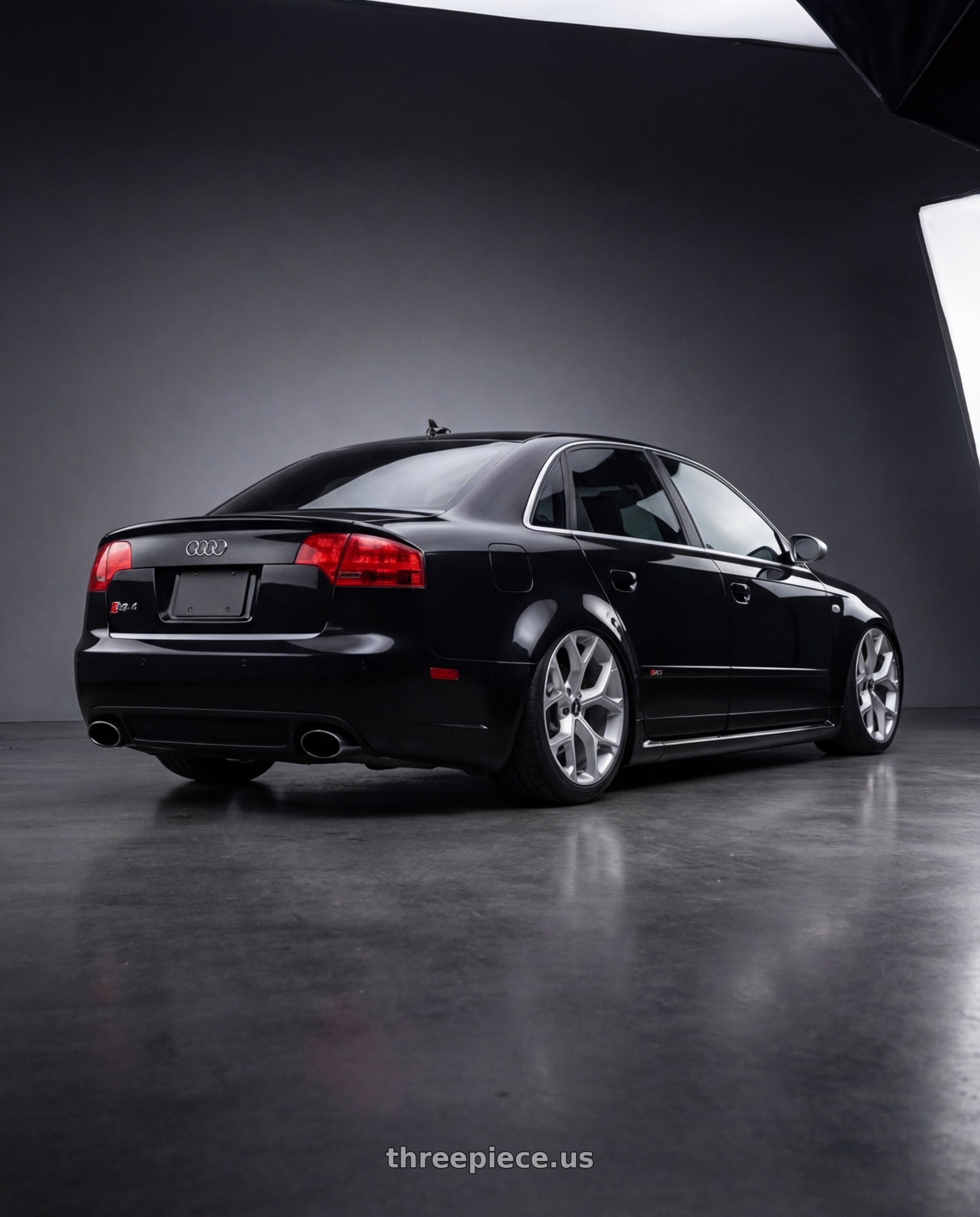 2007 audi rs4 black with Xcess 5 Flake 5x108 18x8.5 +35 Silver Machined wheels rear three quarter view meaty tires