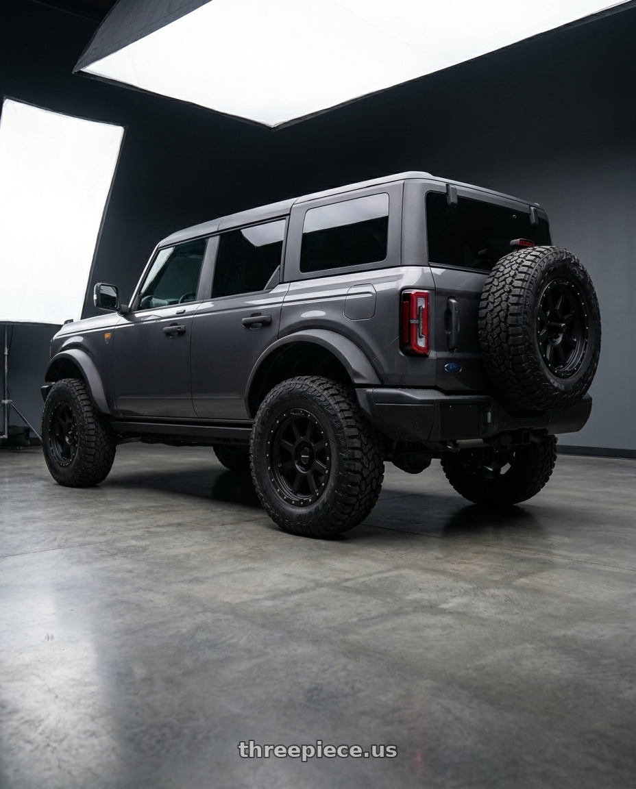 2023 Ford Bronco Badlands with Vision Off-Road 350 Ojos 6x139.7 17x9+12 Satin Black wheels rear three quarter view square tires