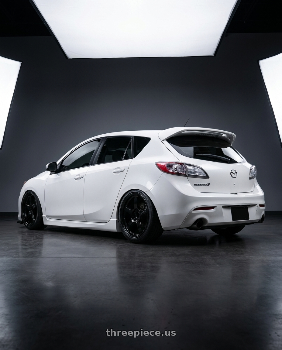 2012 Mazda Mazdaspeed3 with Gram Lights 57CR 5x114.3 18x9.5+22 Glossy Black wheels rear three quarter view slight stretch tires