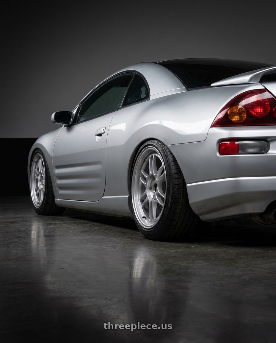 2003 Mitsubishi Eclipse GS with Enkei RPF1 5x114.3 17x8+35 Silver wheels rear three quarter view slight stretch tires