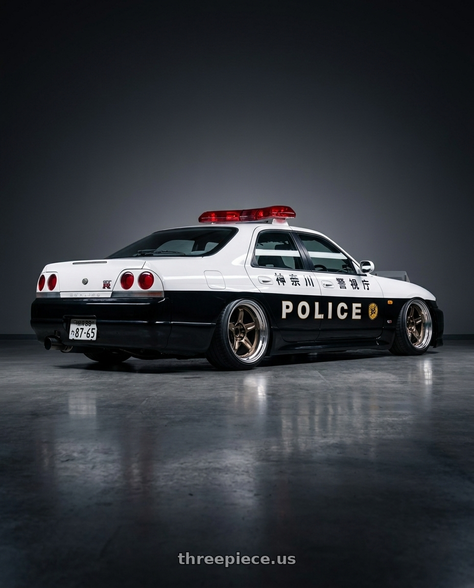 1998 Nissan Skyline GT-R Autech 神奈川県警視庁 with Volk Racing 21C SPEC-SR 5x114.3 18x10.5 +15 SHINING BRONZE METAL / RIM DC wheels rear three quarter view slight stretch tires