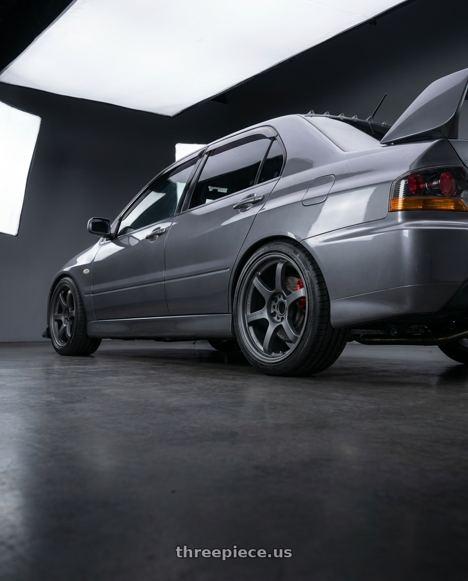 2005 Mitsubishi lancer evo with Gram Lights 57DR 5x114.3 18x8.5+37 Gunblue II wheels rear three quarter view square tires