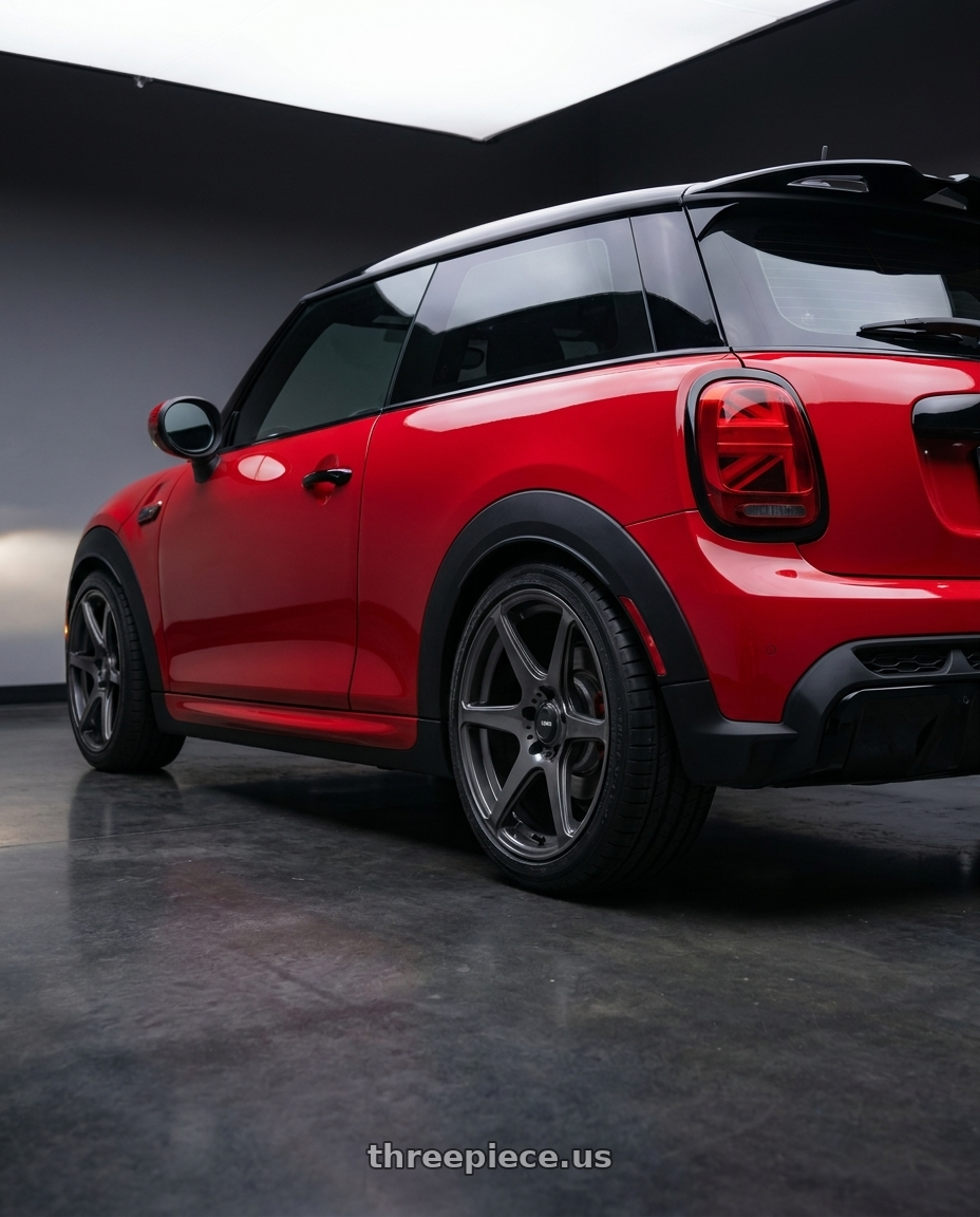 2025 mini jcw red with Konig 104GG Tandem 5x112 18x8 +43 Gloss Graphite wheels rear three quarter view square tires