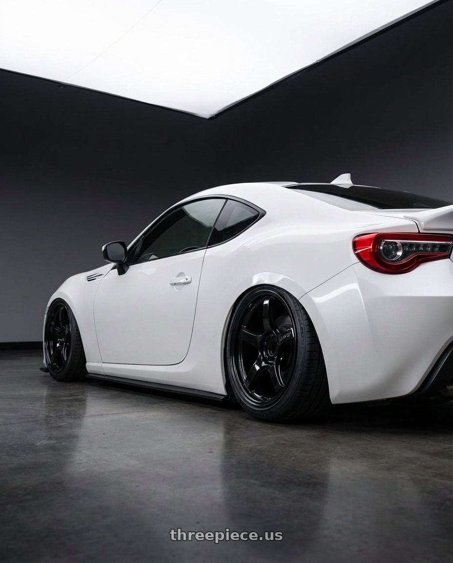 2016 Scion FR-S with Gram Lights 57CR 5x100 18x8.5+45 Glossy Black wheels rear three quarter view slight stretch tires