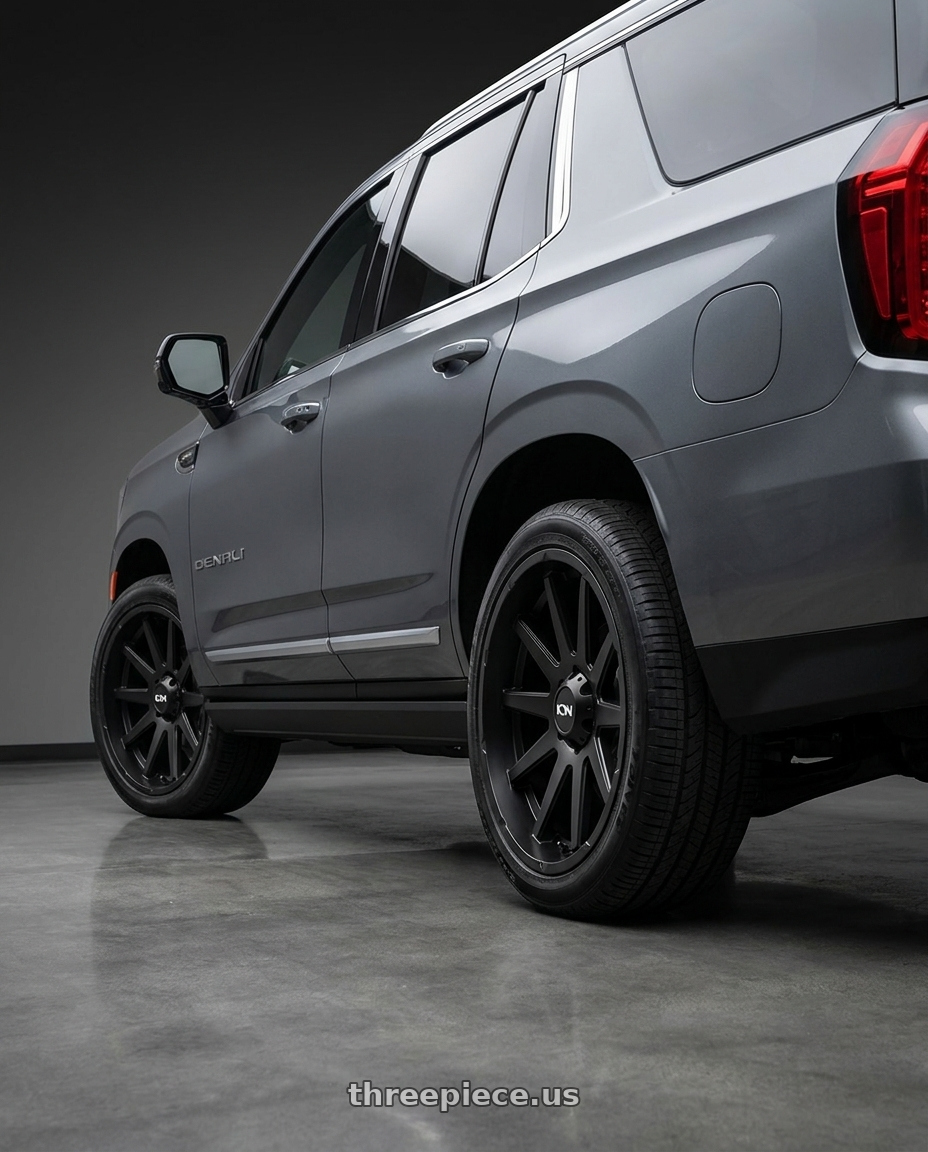 2021 GMC Yukon Denali with Ion Type 143 6x139.7 20x9+0 Matte Black wheels rear three quarter view square tires