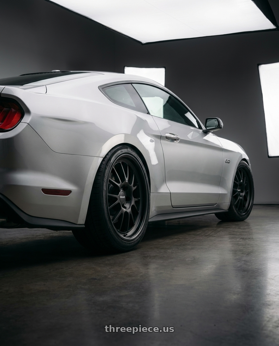 2018 Ford Mustang with Klutch SL14 5x114.3 18x9.5  +35 Matte Black wheels rear three quarter view square tires