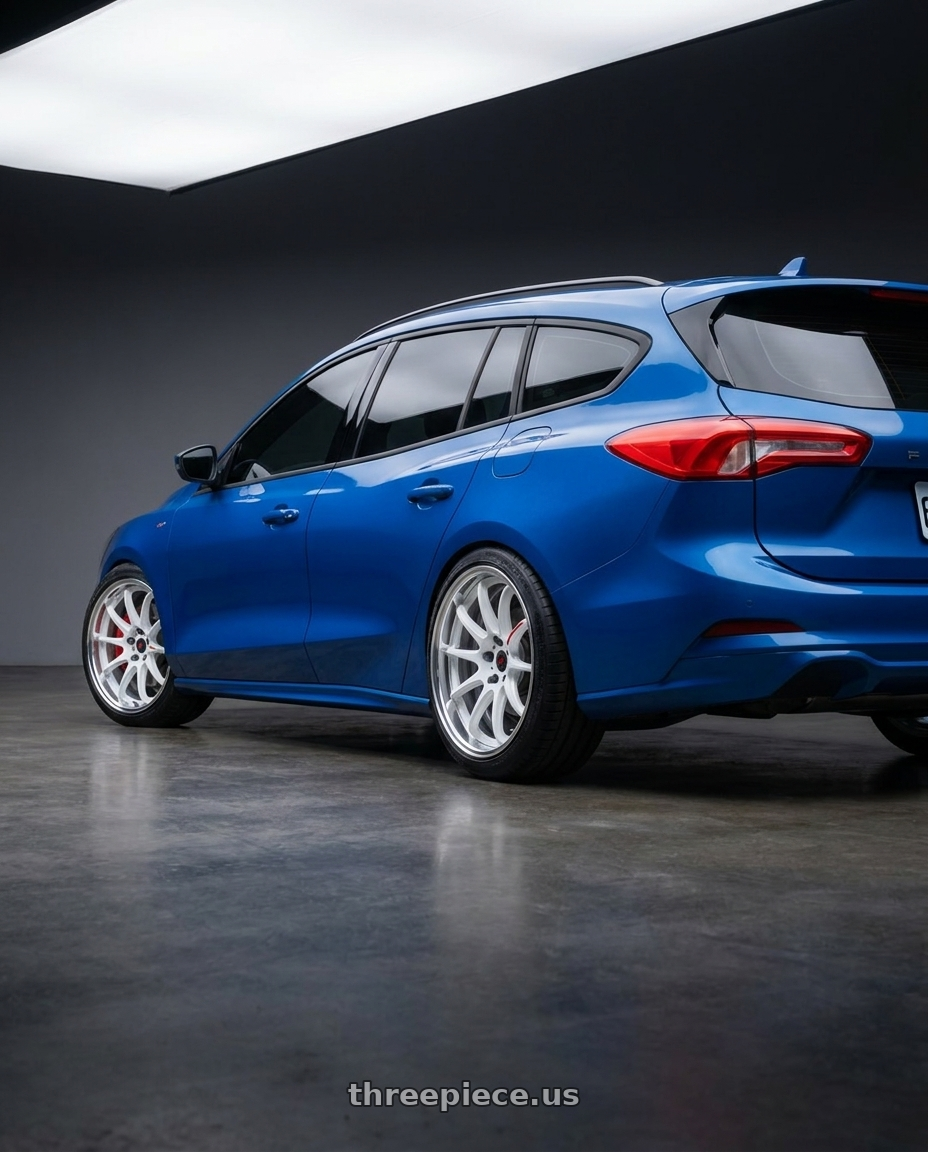 2023 Focus wagon with Work Zr10 2P 5x108 18x10.0 +12 Azure White wheels rear three quarter view square tires