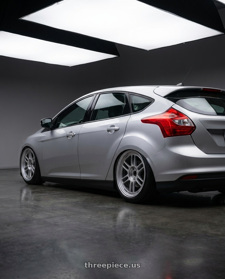 2011 Ford focus with Enkei RPF1 5x100 16x7+35 Silver wheels rear three quarter view slight stretch tires