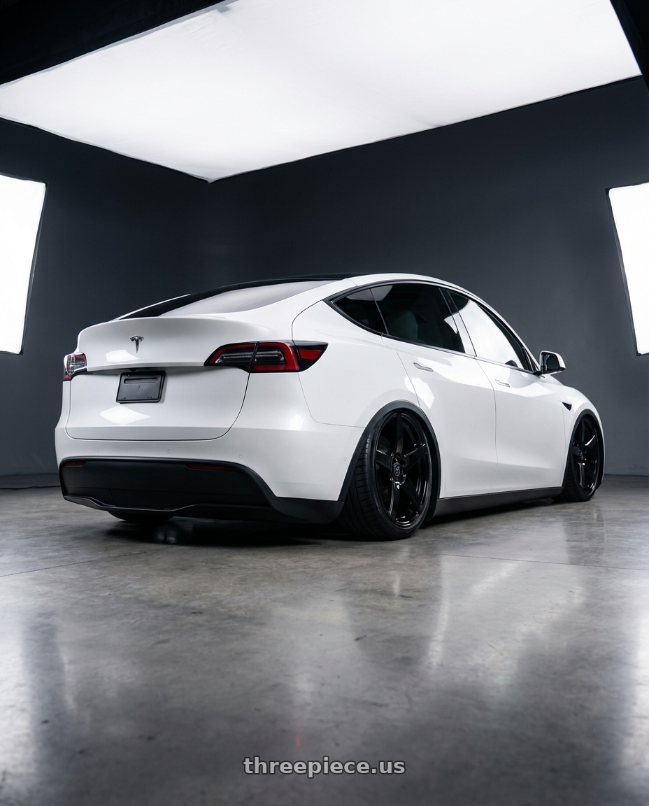 2024 Tesla Model Y with Forgestar CF5 5x114.3 20x9 +35 Gloss Black wheels rear three quarter view slight stretch tires