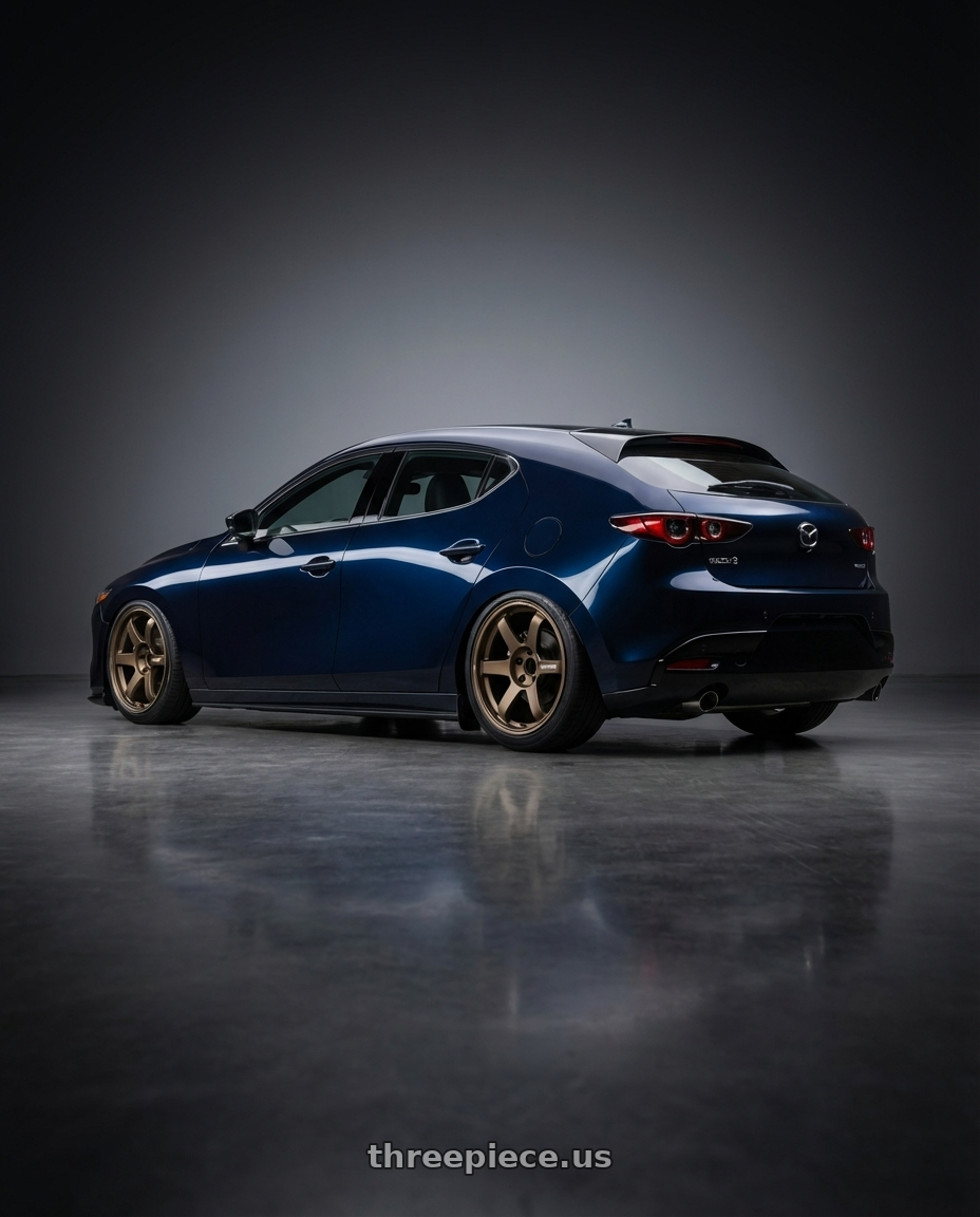 2025 Deep Mica Blue Mazda 3 Hatchback with AeroKit with Volk Racing TE37 Saga S-Plus 5x112 18x10.5+30 Bronze wheels rear three quarter view slight stretch tires