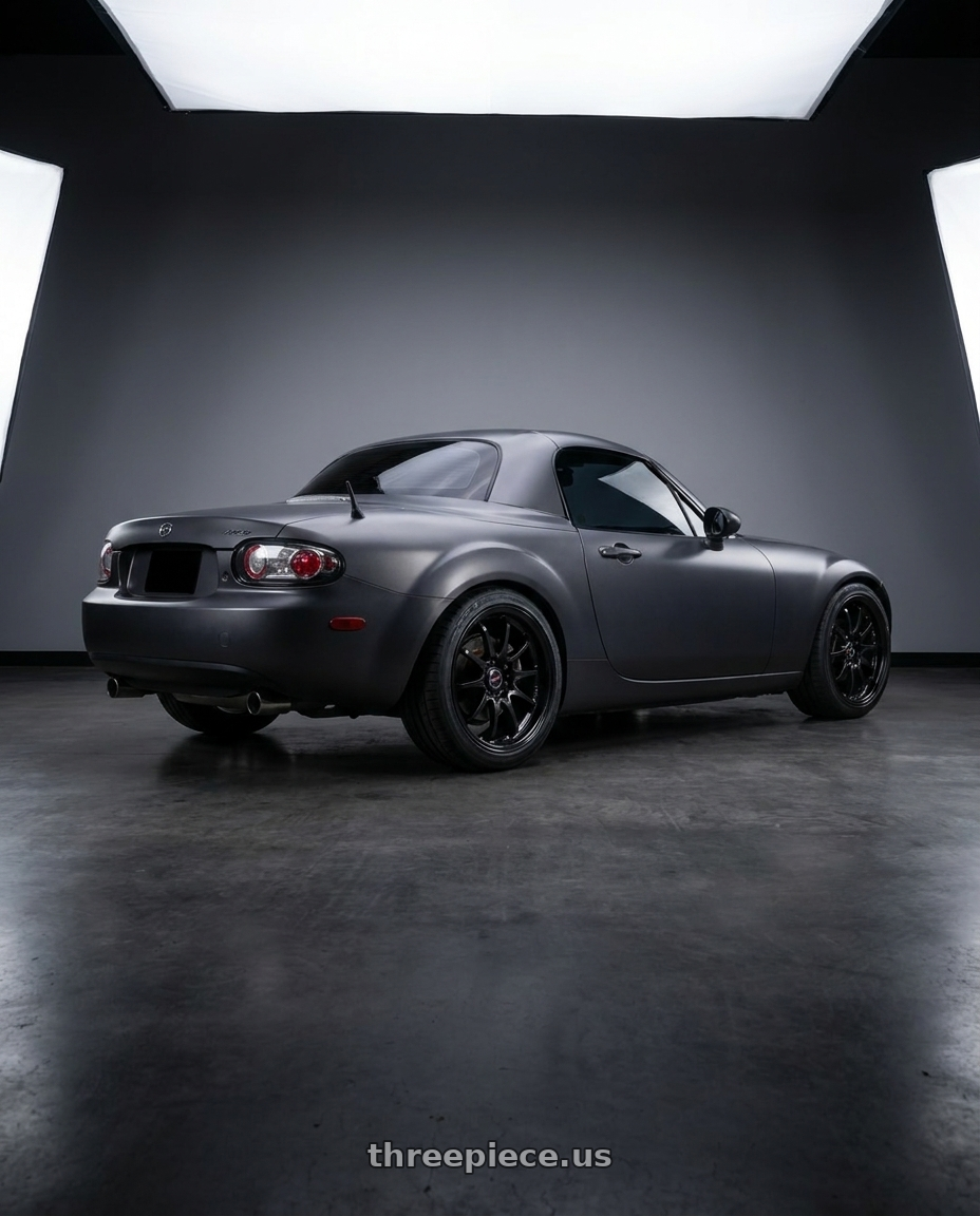 2007 Mazda Miata MX-5 with Volk Racing CE28N-PLUS 5x114.3 18x7.5+48 Diamond Black wheels rear three quarter view square tires