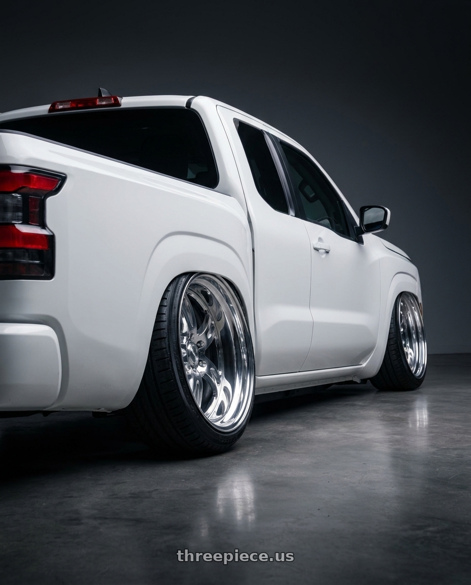 2025 nissan frontier king cab with Heritage Wheel AVUS wheels rear three quarter view extreme stretch tires