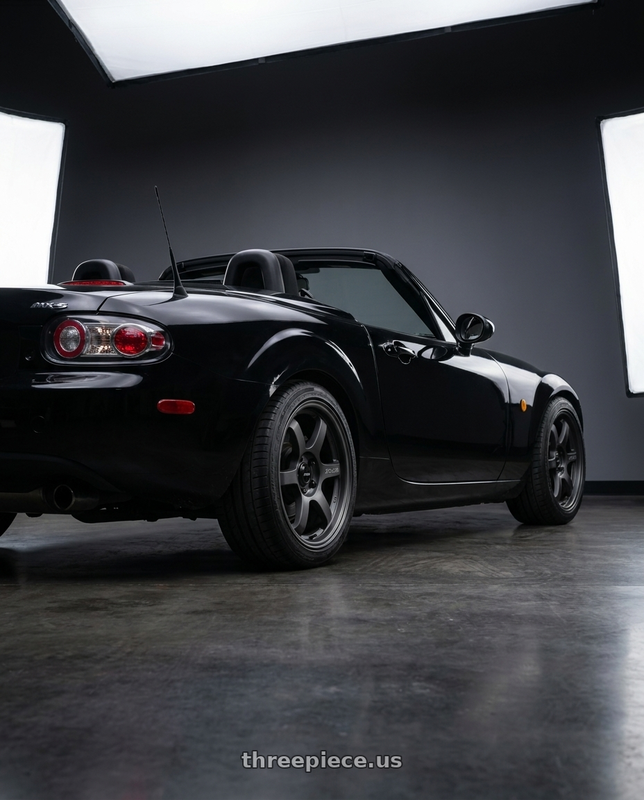 2006 Mazda MX-5 Miata with Gram Lights 57DR-X2 5x114.3 16x7+32 Black Graphite wheels rear three quarter view square tires