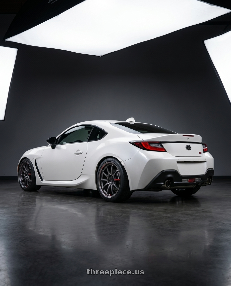 2026 Toyota gr86 with Volk Racing CE28N-PLUS SL 5x100 18x8.5+44 Pressed Graphite wheels rear three quarter view square tires